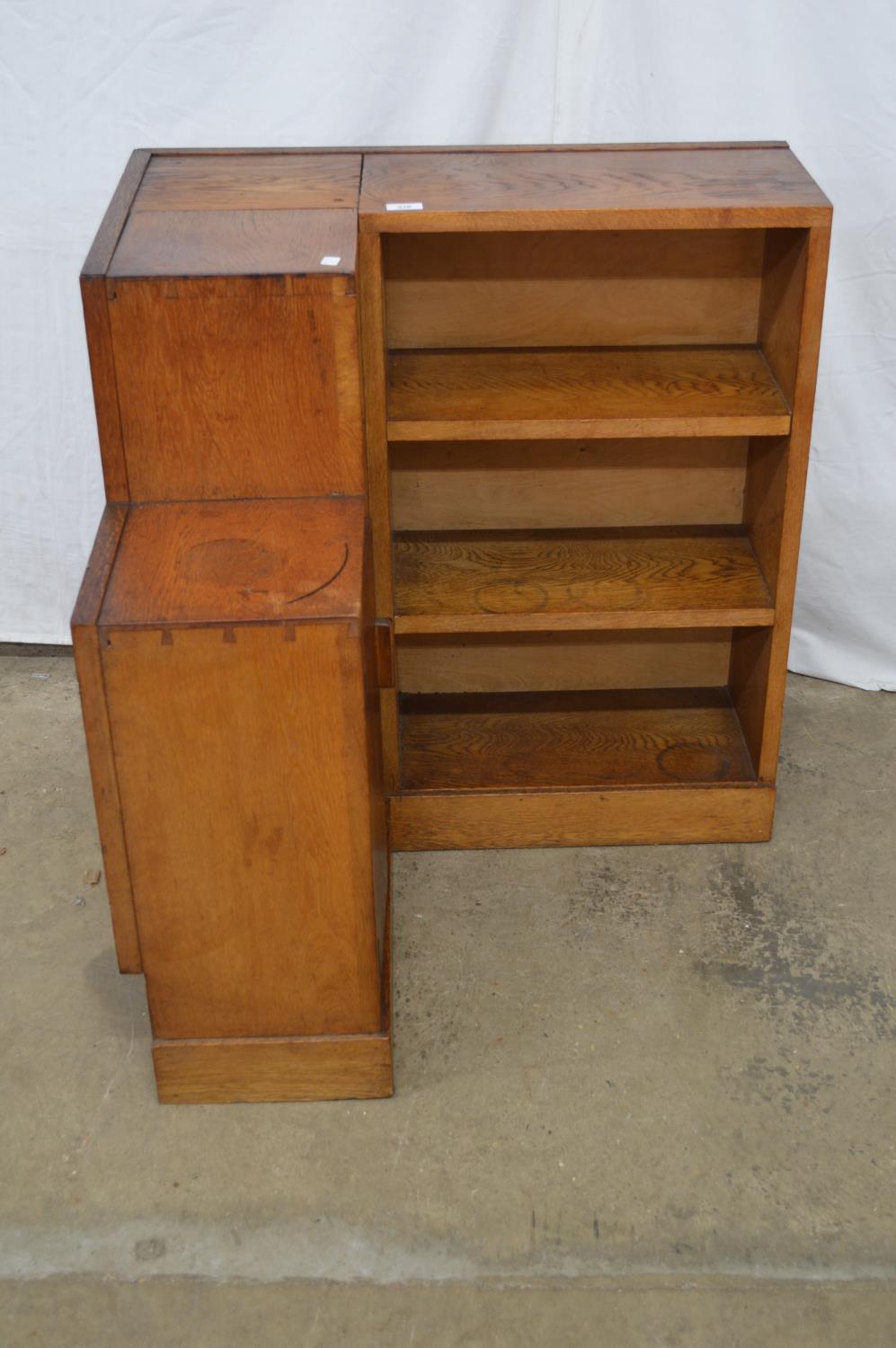 Oak corner bookcase having four fixed shelves and single cupboard door enclosing single shelf - 74cm
