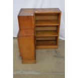 Oak corner bookcase having four fixed shelves and single cupboard door enclosing single shelf - 74cm
