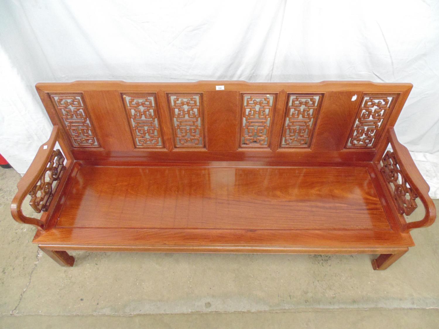 20th century Chinese hardwood bench having pierced back and arms, solid seat and standing on - Image 5 of 5