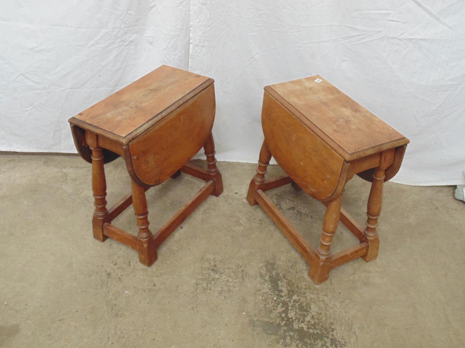 Pair of mahogany drop flap rotating top occasional tables standing on four turned legs with cross