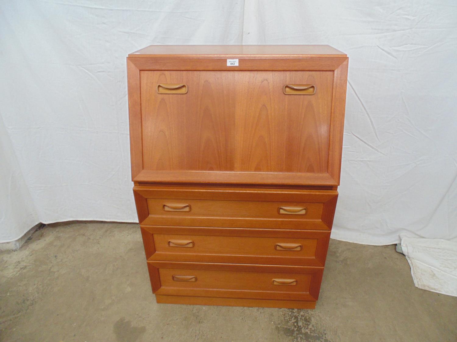 Mid century teak bureau the fall front opening to pigeon holes and a single drawer over three