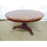 Mahogany coffee table, the circular top over a hexagonal tapered column leading to a triform base