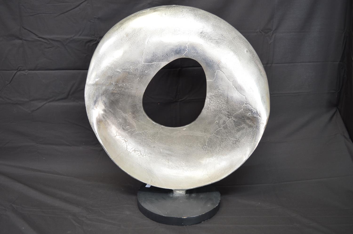 Modern aluminium circular sculpture on circular wooden base - 63cm tall Please note descriptions are