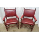 Pair of mahogany elbow chairs having padded red leather backs, arms and seat with stud work