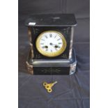 Slate and marble mantle clock with gilt highlights, white enamel dial, black Roman Numerals and
