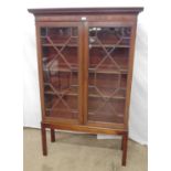 Mahogany bookcase on stand the two astral glazed doors opening to three adjustable shelves, standing