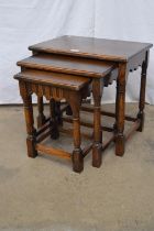 Nest of three oak tables standing on block and turned legs - largest 51cm x 35.5cm x 48.5cm tall