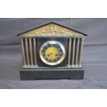 Slate cased mantle clock having gilt insert depicting knights in battle over a brass dial with black