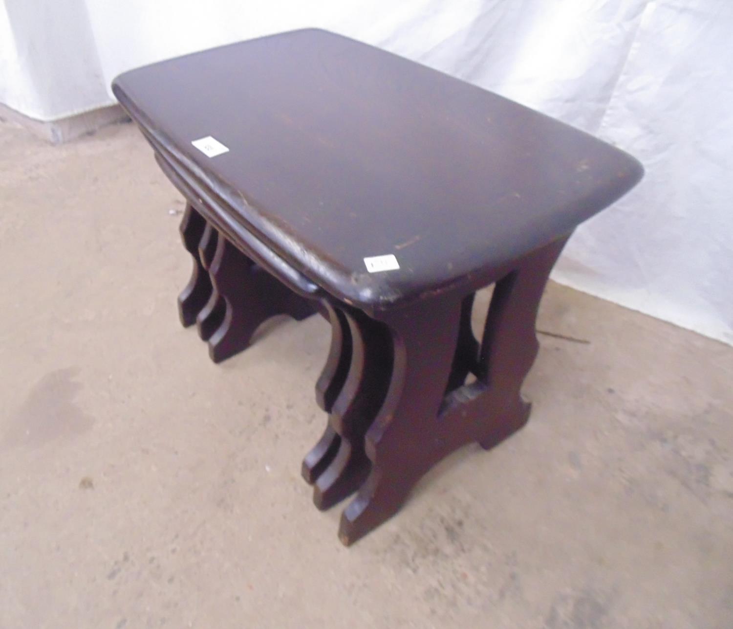 Nest of three dark Ercol style elm tables standing on pierced shaped legs - largest 58cm x 36cm x - Image 2 of 4