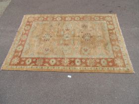 Mustard ground wool rug with rust pattern and end tassels - 2.04m x 1.83m Please note descriptions