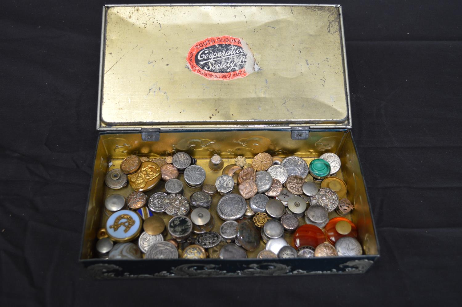 Tin containing a collection of silver and other gentleman's studs Please note descriptions are not