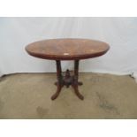 Inlaid walnut loo table having oval top standing on tour turned legs leading to central finial and