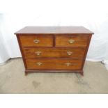 Mahogany chest of two short and two long drawers with brass swan neck handles, standing on splay