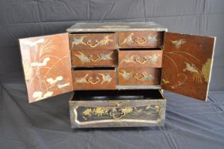 Japanese lacquered table top cabinet having two doors opening to reveal six small drawers over