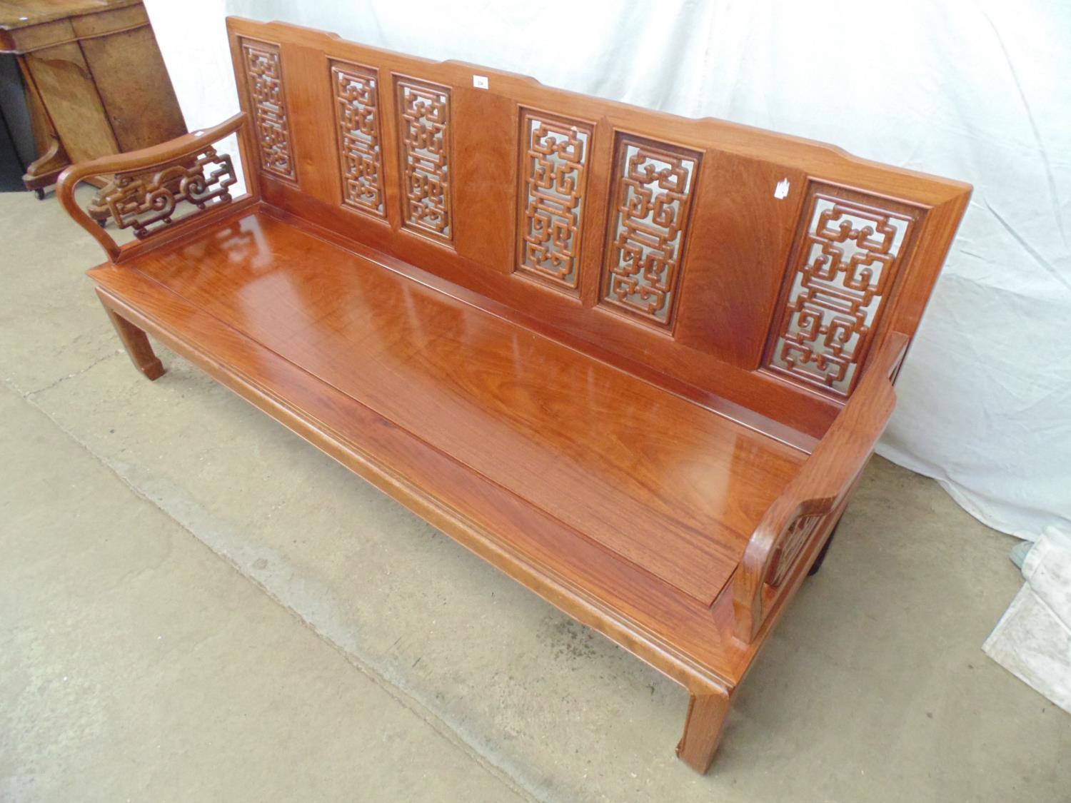 20th century Chinese hardwood bench having pierced back and arms, solid seat and standing on - Image 2 of 5