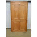 Victorian pine floor standing corner cupboard having moulded cornice over four panelled doors, the