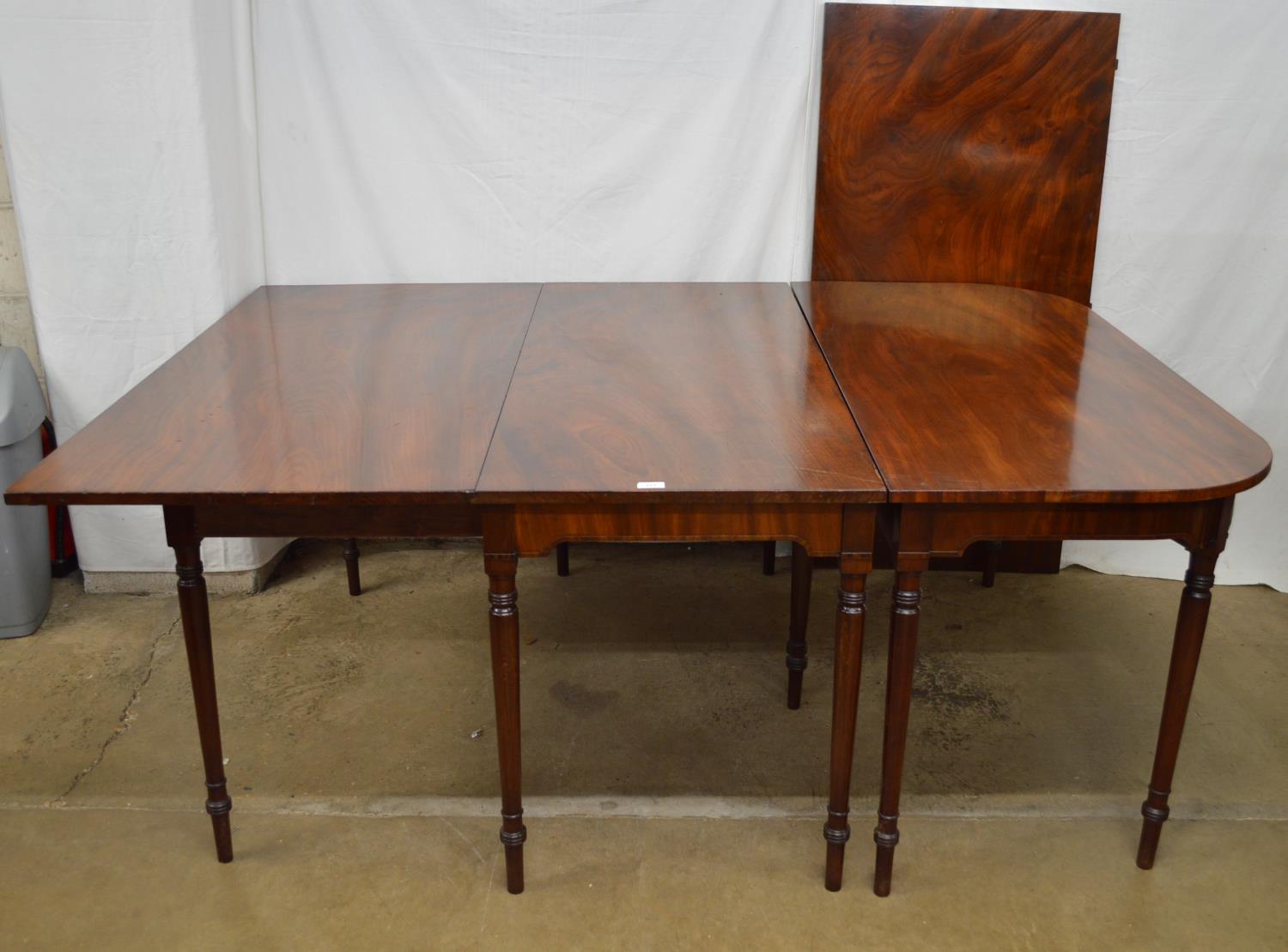 Georgian mahogany dining table with drop leaf and extra leaf, standing on turned legs - 257.5cm (