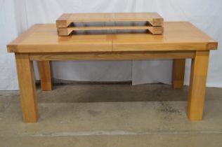 Light oak extending dining table with two additional leaves, standing on square moulded legs - 260cm