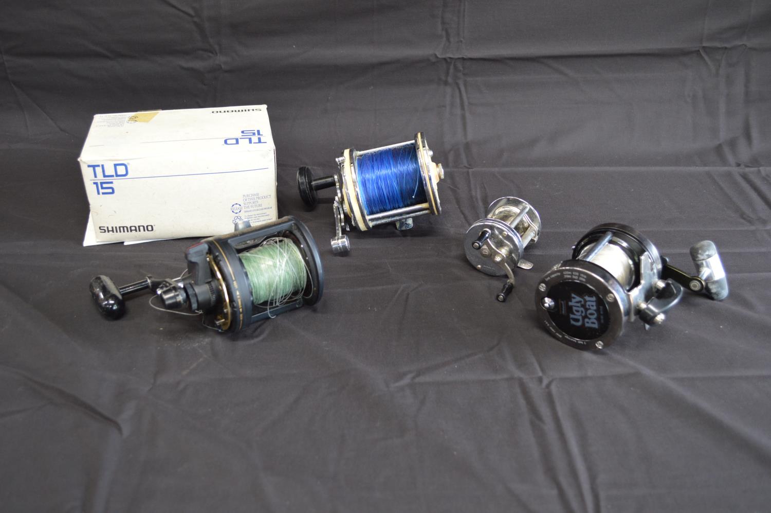 Group of four fishing reels to comprise: Shakespeare Leader No. 1909, Ugly Boat 2916 301, Shimano
