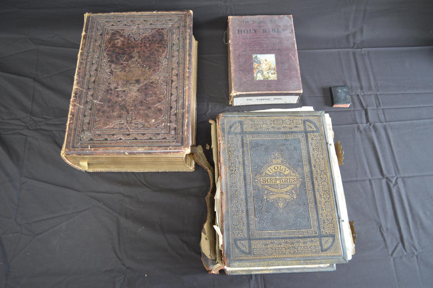 Two leather bound family Bibles together with the Copping Bible in a box and The Book Of Common