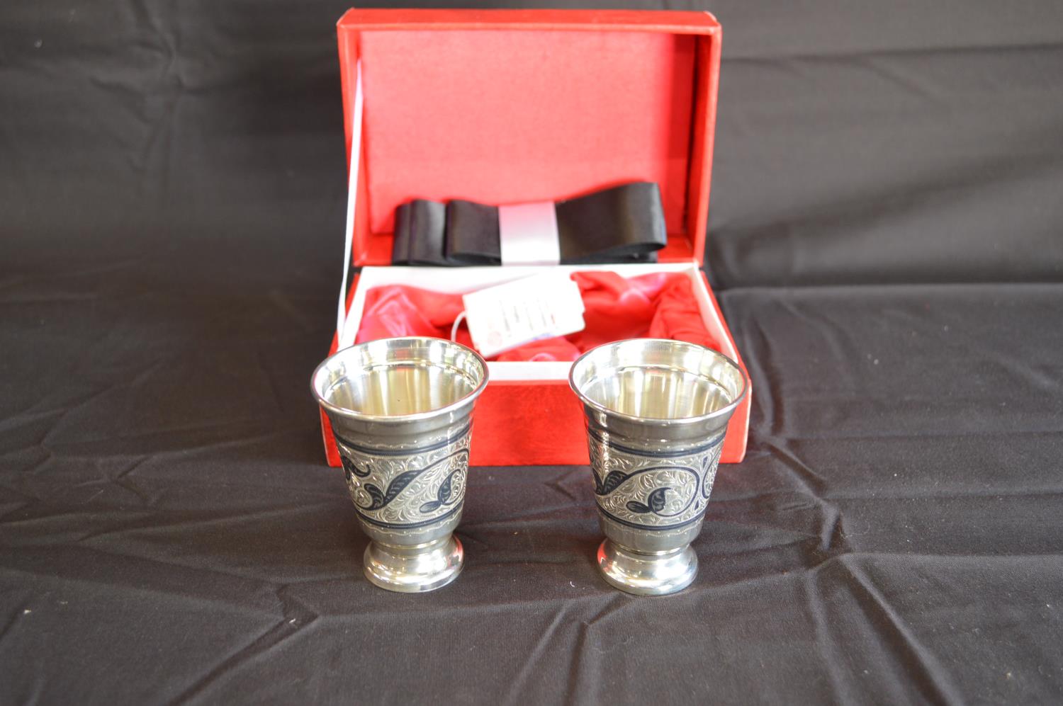 Pair of boxed .875 silver engraved tapering beakers (4.9ozt) Please note descriptions are not