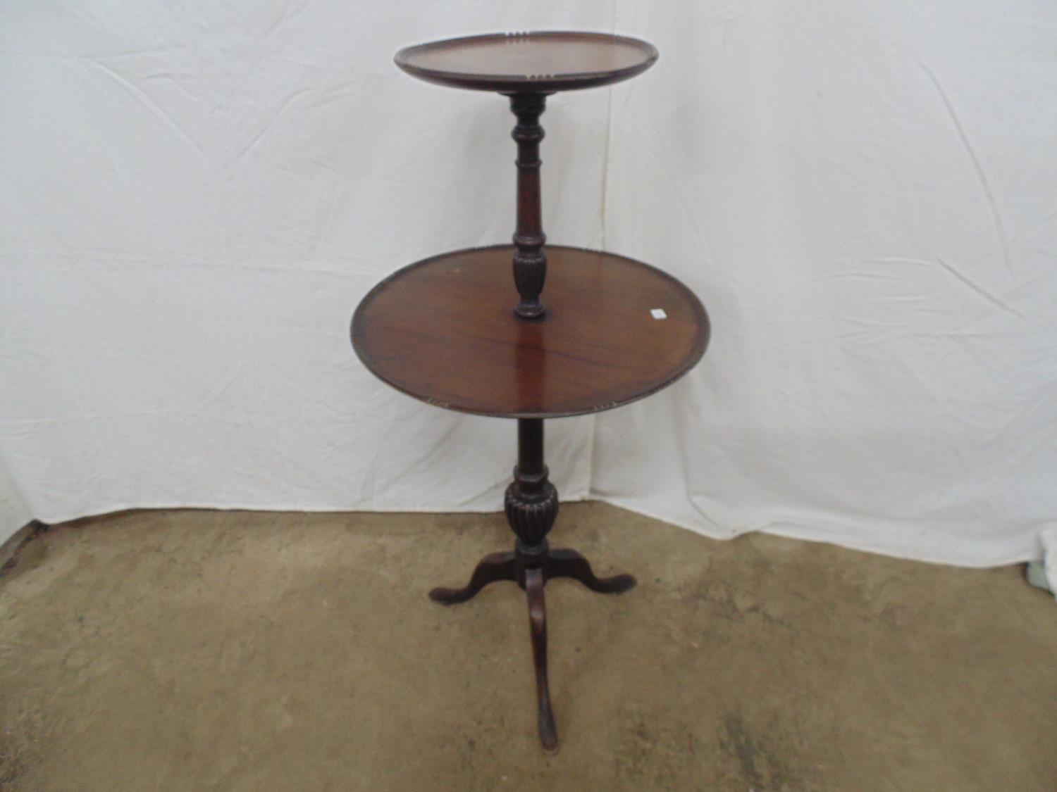 Mahogany two tier dumb waiter on turned column ending in three cabriole legs - 50cm dia x 107cm tall