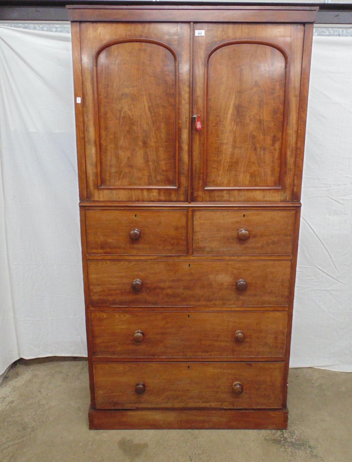 Victorian mahogany cupboard on chest the arched panelled doors opening to a single fixed shelf