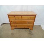 Wood effect chest of two short and two long drawers, standing on bracket feet - 104cm x 45cm x