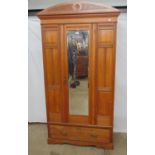 Edwardian satinwood single door wardrobe, the mirrored door enclosing an interior with fitted hooks,