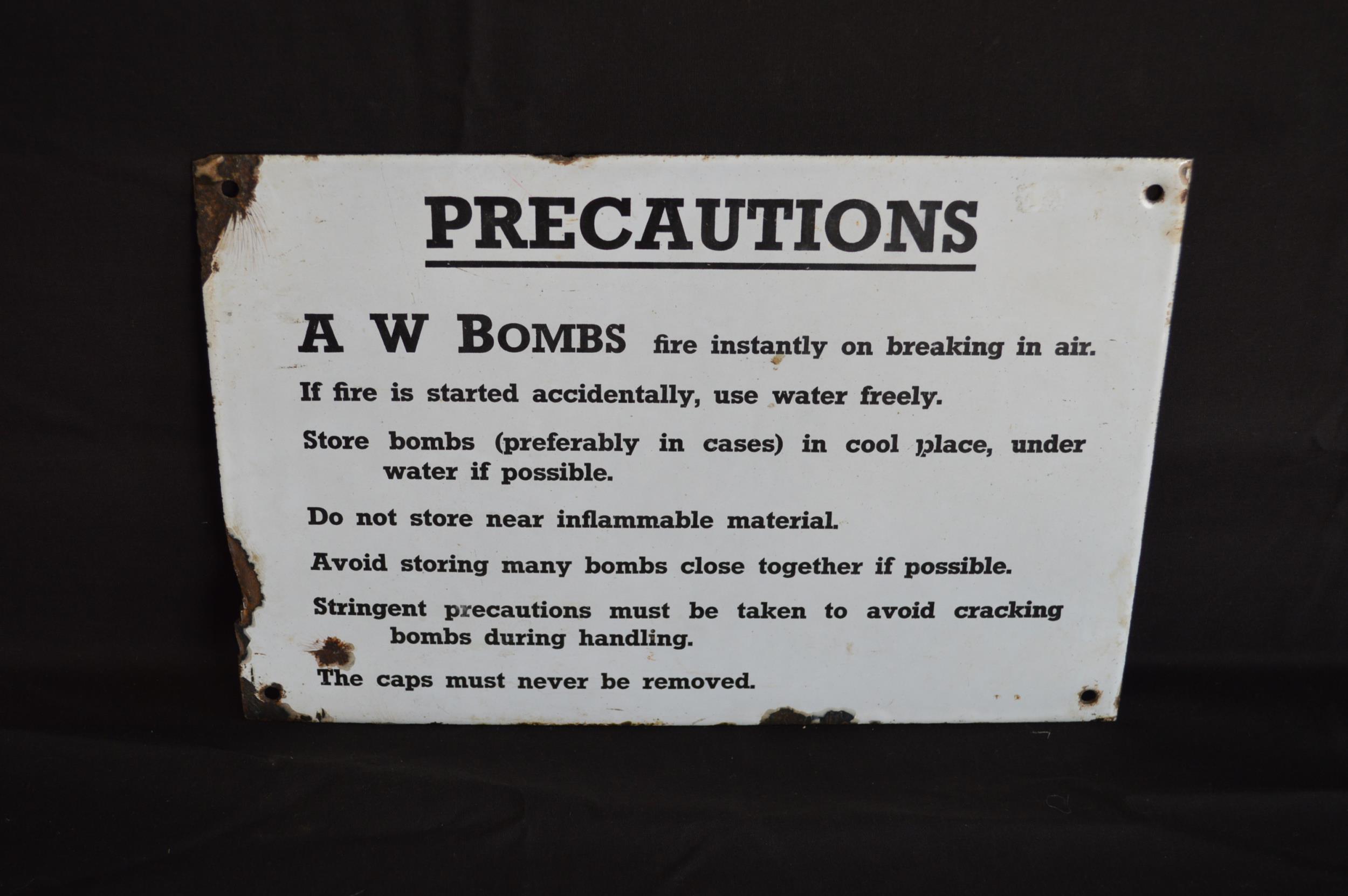 A.W Bombs enamel precautions sign having black lettering on a white ...