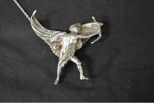 Silver pin brooch designed by Fredrick Massingham depicting Eros, with later added safety chain. - Image 2 of 4