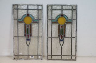 Pair of early 20th Century leaded glass stained glass windows each featuring an Art Nouveau design