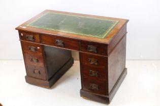 Late 19th century Mahogany Twin Pedestal Desk with green leather inset top, an arrangement of nine