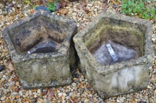 Two reconstituted stone garden planter pots of pentagonal form with moulded columns to the sides.