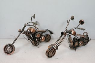 Two brushed copper coloured metal motorbike models with wirework detailing. Measures 82cm wide.