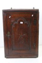 George III Oak Inlaid Hanging Corner Cabinet, the single door opening to shelves, 85cm high x 58cm