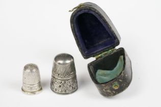 Silver thimble containing smaller white metal thimble, in original silk and velvet lined leather