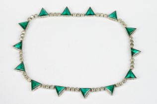 Art Deco paste white metal riviere necklace, fourteen green glass triangular panels with a row of