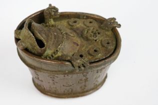 A Chinese cast metal incense burner in the form of Chan Chuy in the bath.