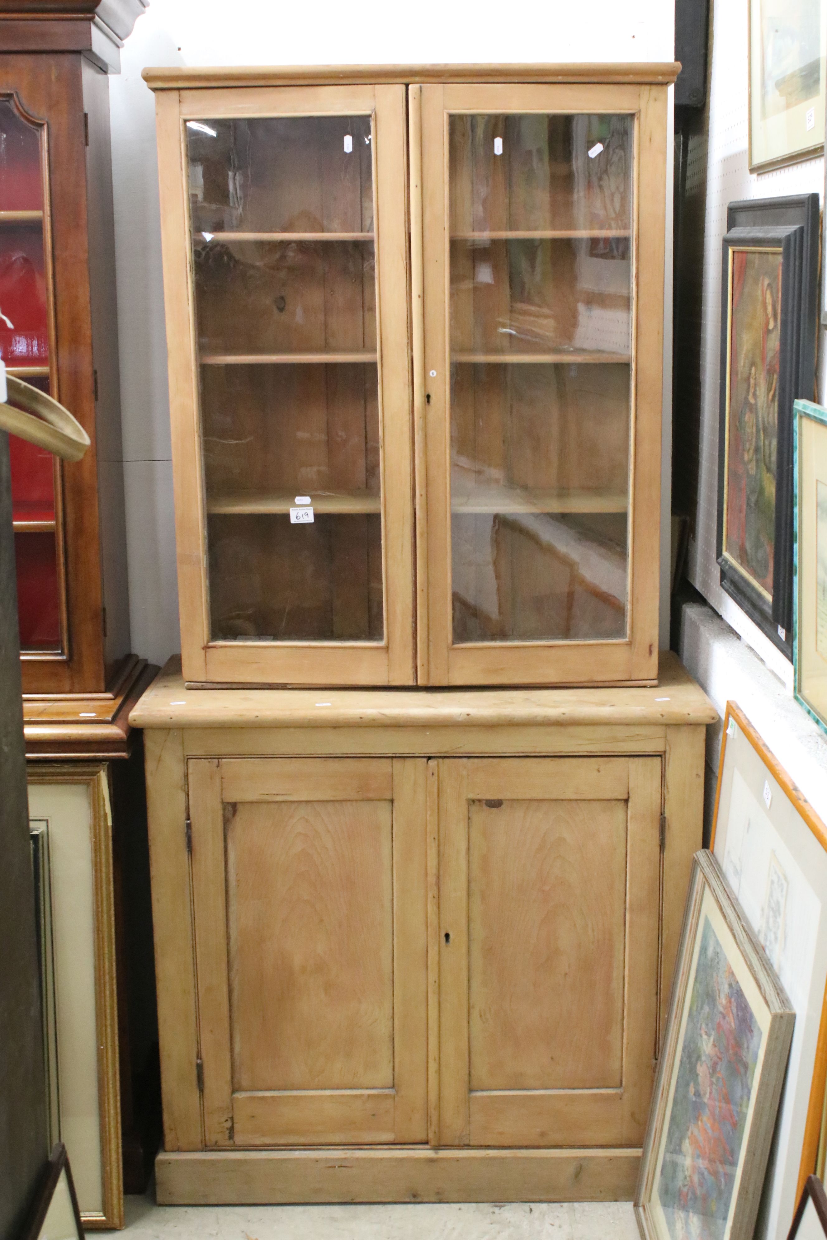 19th century Pine Dresser, the top with two glazed doors opening to three shelves, the base with two