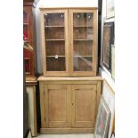 19th century Pine Dresser, the top with two glazed doors opening to three shelves, the base with two