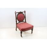 Edwardian Mahogany Nursing Chair, the oval upholstered splat with ribbon carving, upholstered