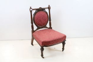 Edwardian Mahogany Nursing Chair, the oval upholstered splat with ribbon carving, upholstered