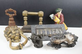 Mixed metalware to include a brass lion door knocker, cast iron bell doorstop, cat iron doorstop