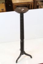 19th century Mahogany Torchere, the circular top raised on a carved turned column with three splayed