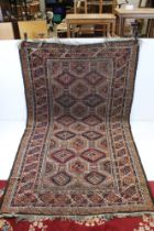 Eastern Wool Red Ground Rug decorated with geometric pattern within a border, 214cm x 132cm