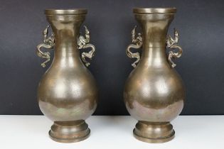 Pair of 20th Century Chinese bronze vases having engraved bird and cloud detailing, each having twin