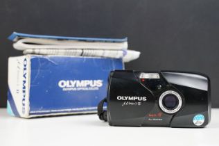 A boxed Olympus M [mju:]-II 35mm compact camera.