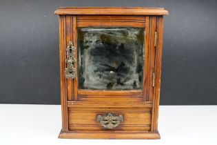 Early 20th century pine smokers cabinet, the door with bevelled mirror to front, drawer below with