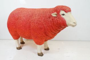 Large painted fibreglass model of a sheep, in red & white. Measures approx 65cm H x 100cm L